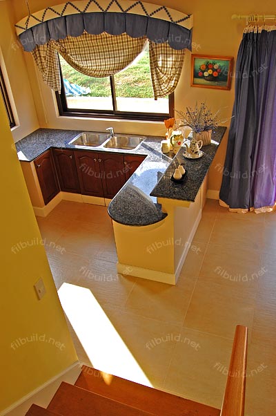View from the stairs looking down the kitchen.