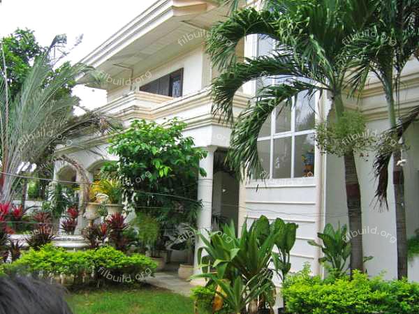 front view of the house with its lush garden